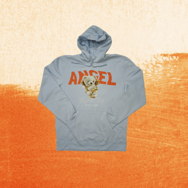 Comfort Fit Hoodie Angel Bear from Mystic Six, showcasing a playful teddy bear angel design with vibrant orange font on a sky blue background. Made with a soft 60-40 cotton blend for warmth and comfort. Streetwear