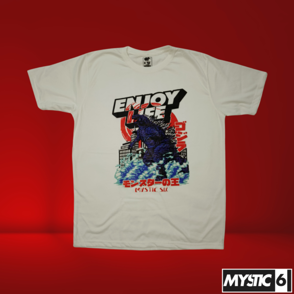 A white T-shirt with a large Godzilla graphic rising from the ocean, featuring bold text that reads "Enjoy Life" and Japanese typography, along with the Mystic Six logo.